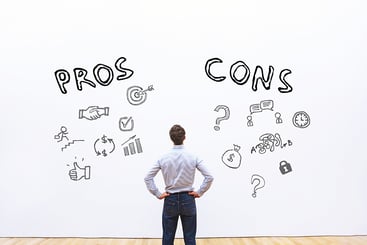 Man Staring at Pros and Cons